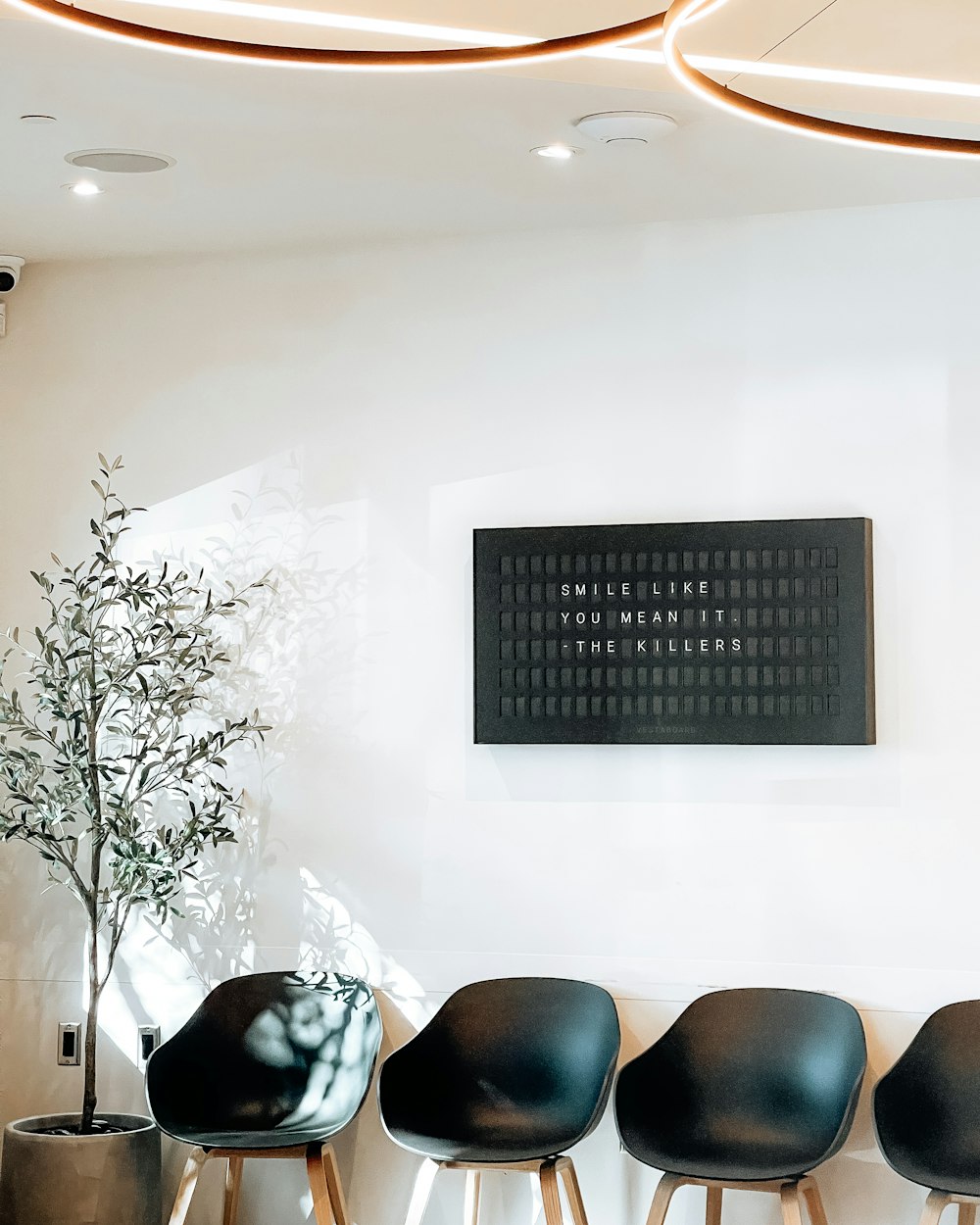A calm, well-lit clinic waiting room with a row of chairs