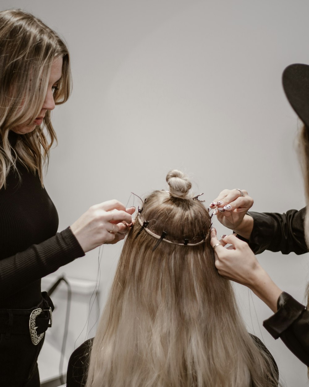 A beauty professional with a client